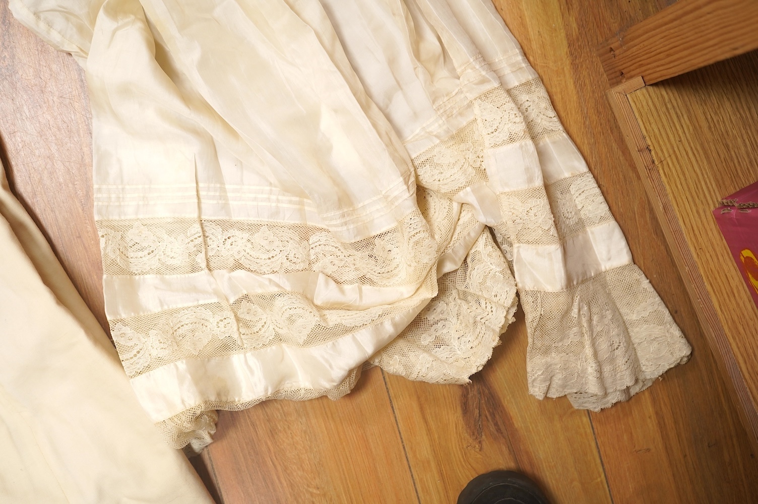 A 19th century cream wool lace and embroidered christening cape and silk baby gown, cape 102cm long. Condition - some stains